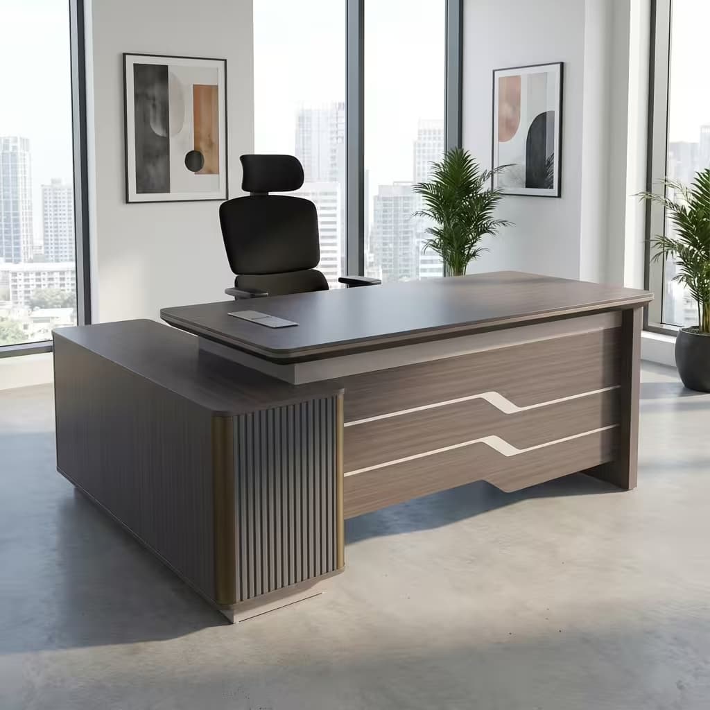 A grey wood grain 1.6m Executive Office Desk featuring a curved-edge tabletop, a brown leather writing insert, a front modesty panel with silver stripe accents, and an integrated side return cabinet with vertical fluting.